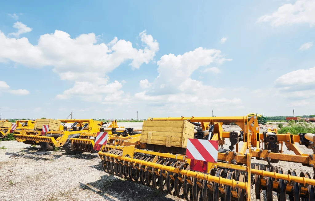 Heavy construction machinery parked on an open worksite under a clear sky