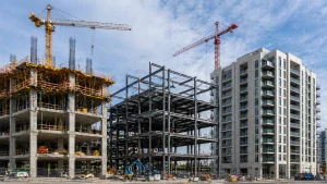 Building construction types skyline: RC frame, steel structure, precast concrete buildings with cranes