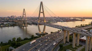 Cable-stayed bridge over river with highway traffic showcasing modern bridge design and infrastructure engineering.