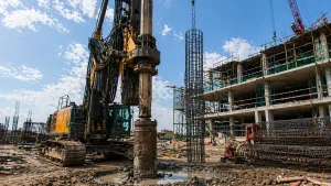 Hydraulic piling rig drilling bored pile with reinforcement cages on construction site