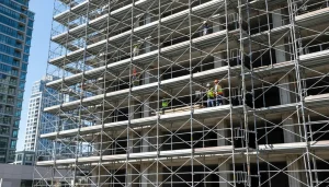 Scaffolding in construction on high-rise building providing safe access for workers performing work at height.