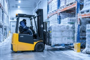 Electric forklift operating inside a frosty cold storage warehouse
